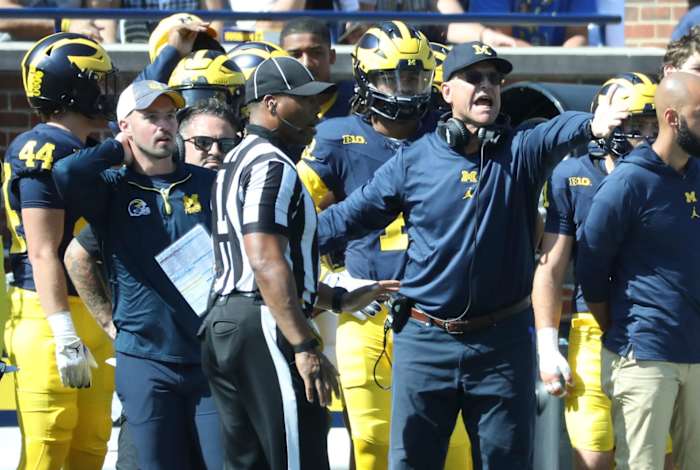 Connor Stalions, left, stands next to Michigan coach Jim Harbaugh during the team's game against Rutgers, Sept. 23, 2023 at Michigan Stadium in Ann Arbor.